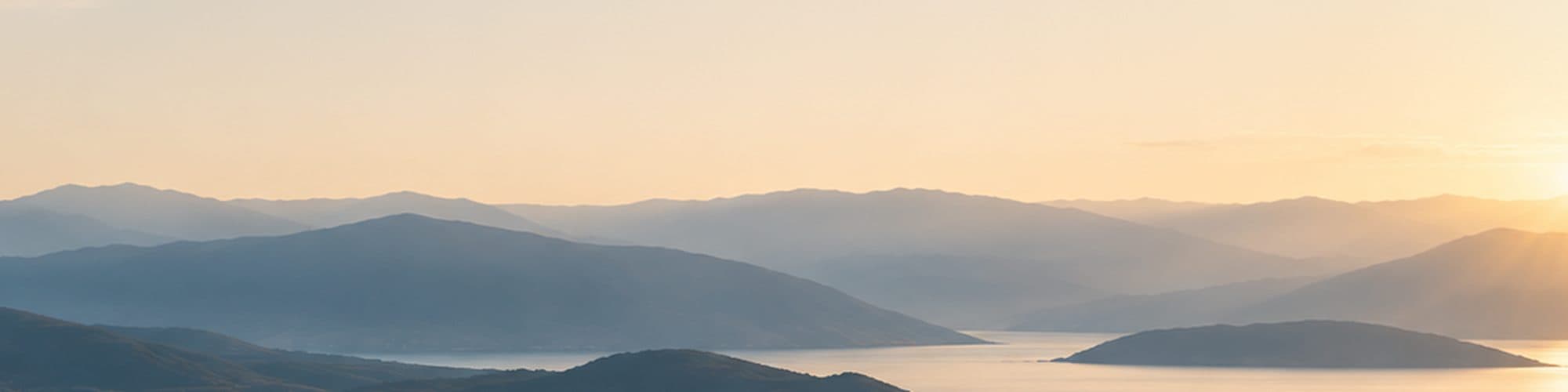 Layered ridgelines above the sea, from the platform's own panorama